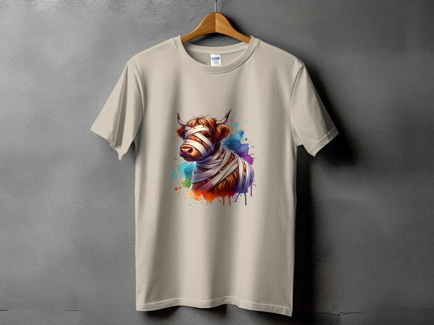 T-shirt with a watercolor Highland cow wrapped in bandages graphic.