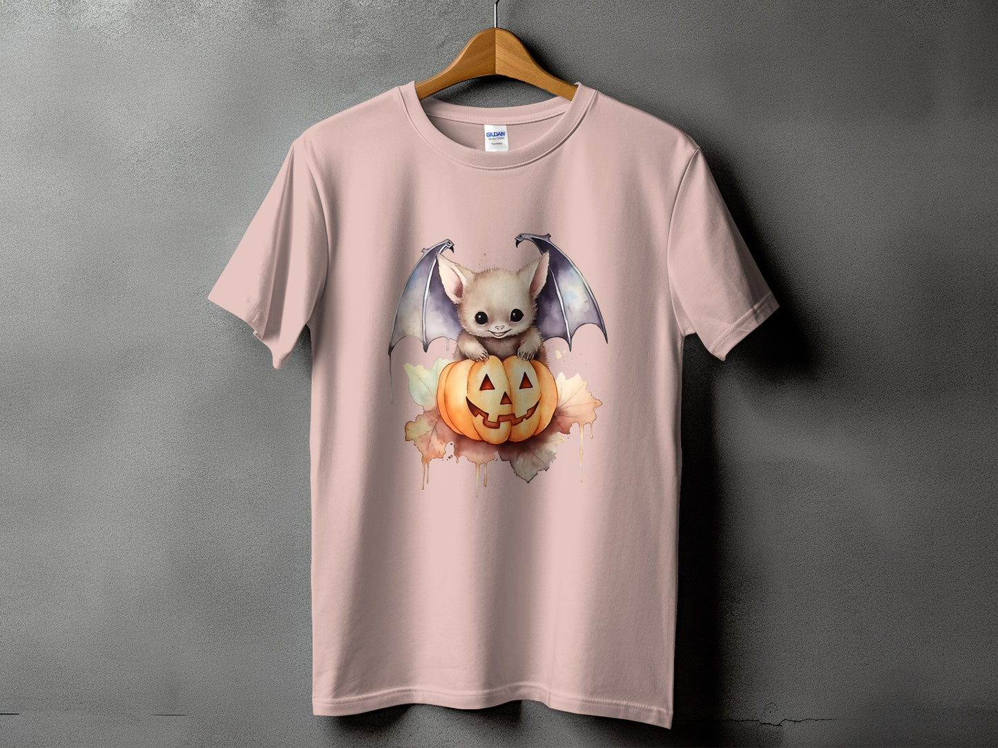 Pink t-shirt with a cute bat sitting on a jack-o'-lantern graphic.