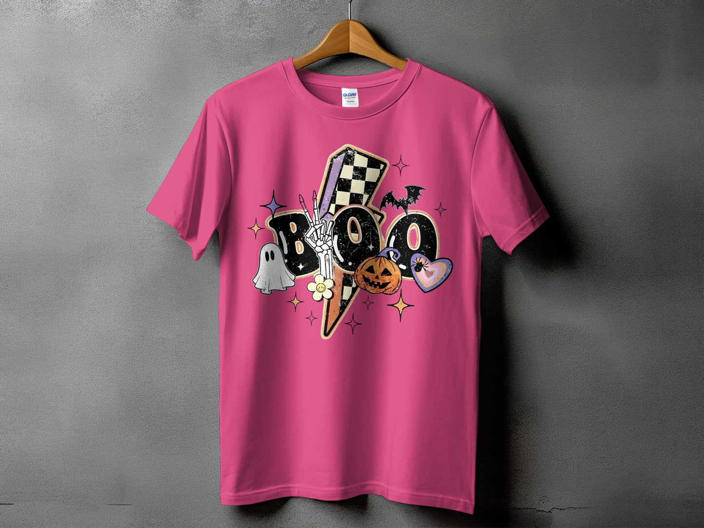 Pink t-shirt with "BOO" in distressed letters and Halloween-themed graphics.