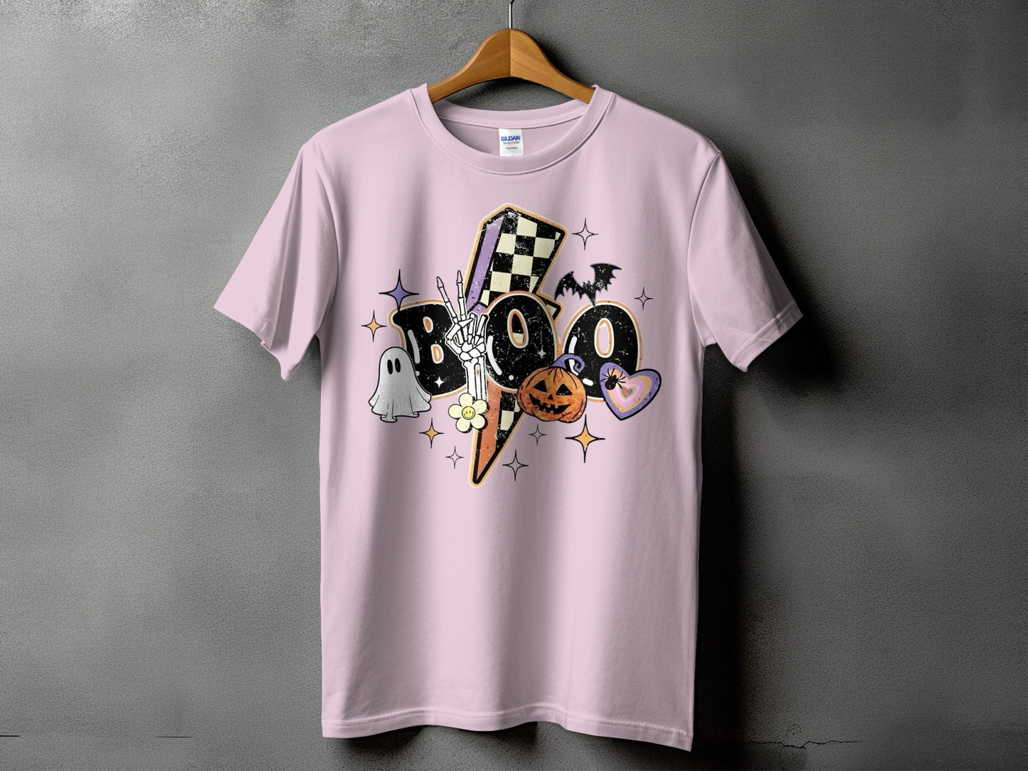Pink t-shirt with a distressed "Boo" graphic featuring Halloween icons.