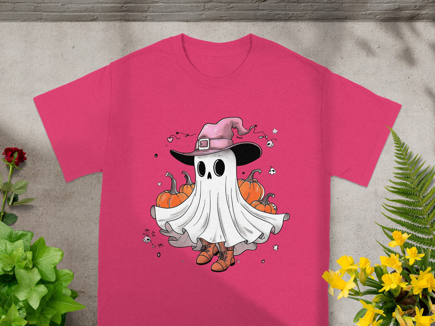 Ghost wearing a witch hat surrounded by pumpkins on a pink t-shirt.
