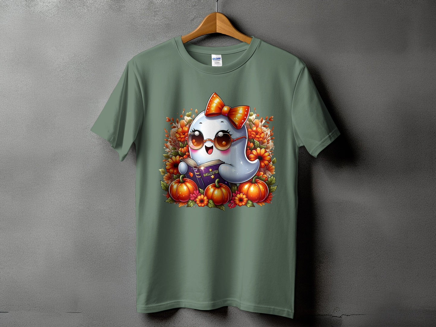 Ghost reading book surrounded by pumpkins and autumn flowers on a green t-shirt.