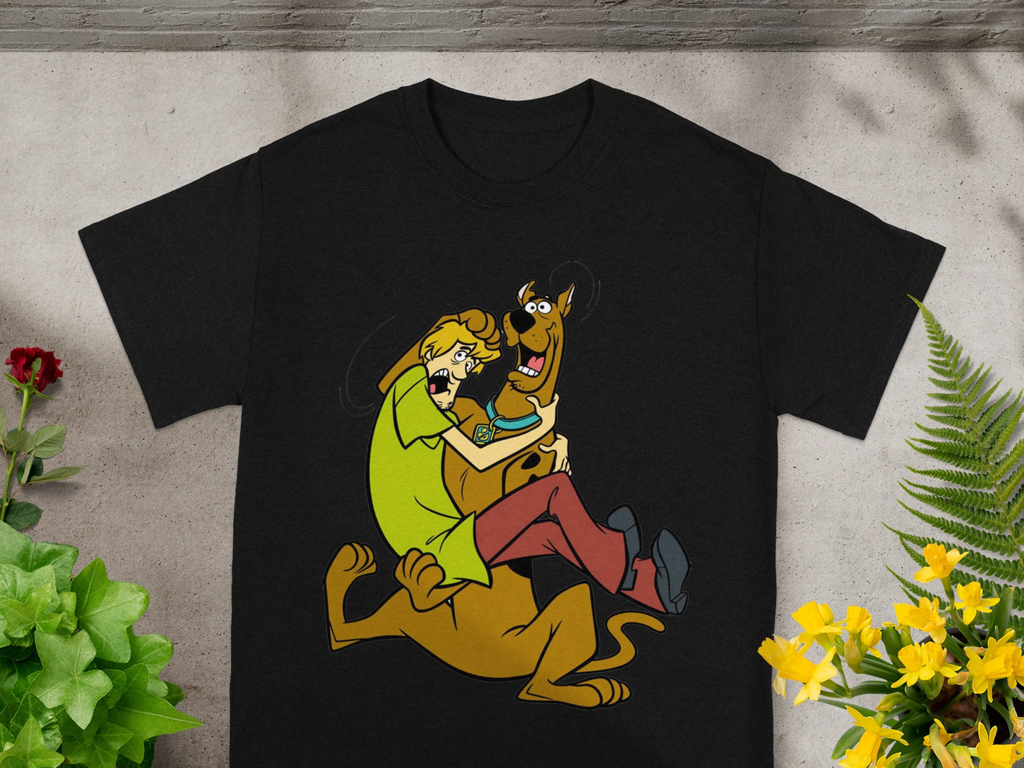 Shaggy and Scooby-Doo in a playful embrace on a black t-shirt.