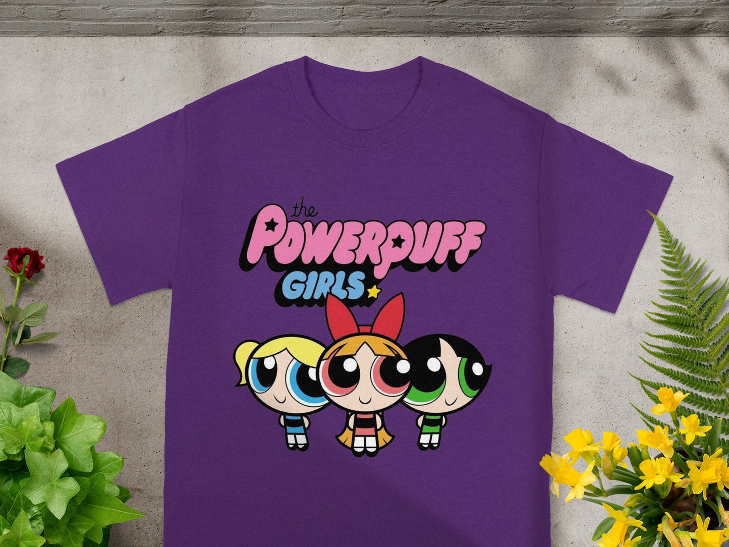 The Powerpuff Girls graphic on a purple t-shirt.