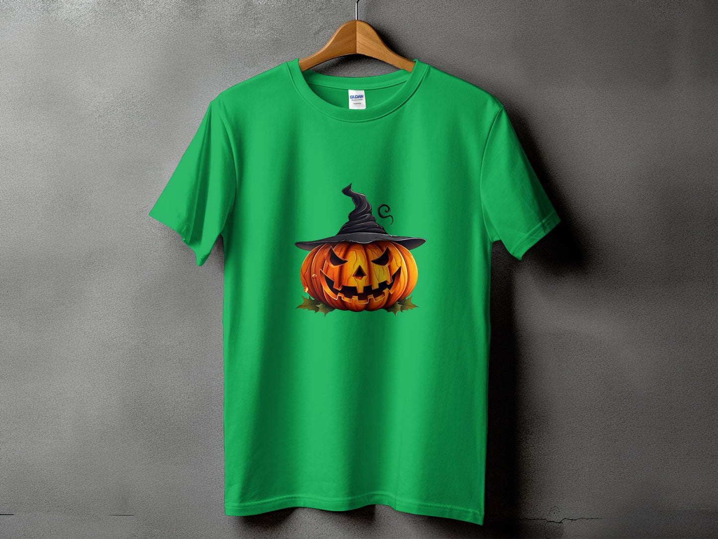 Green t-shirt with a jack-o'-lantern wearing a witch's hat and falling leaves graphic.
