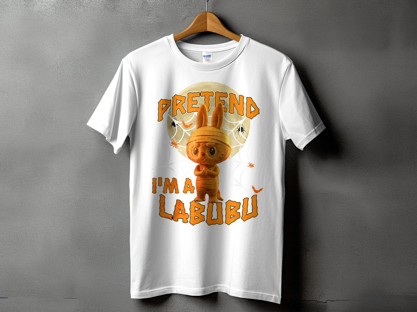 White t-shirt with a mummy bunny character and "PRETEND I'M A LABUBU" text.