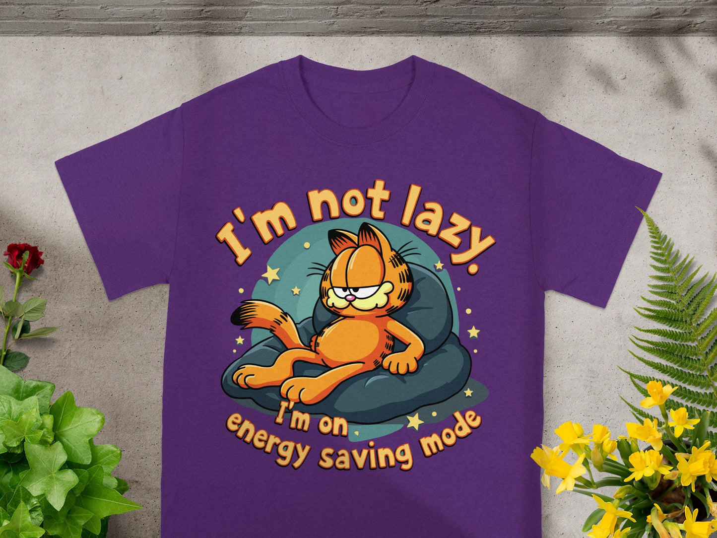 Purple t-shirt with Garfield on a pillow, text "I'm not lazy. I'm on energy saving mode."