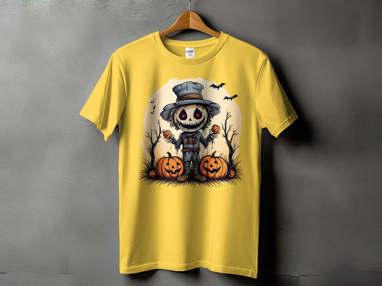 Yellow t-shirt with a Halloween scarecrow and pumpkins graphic.