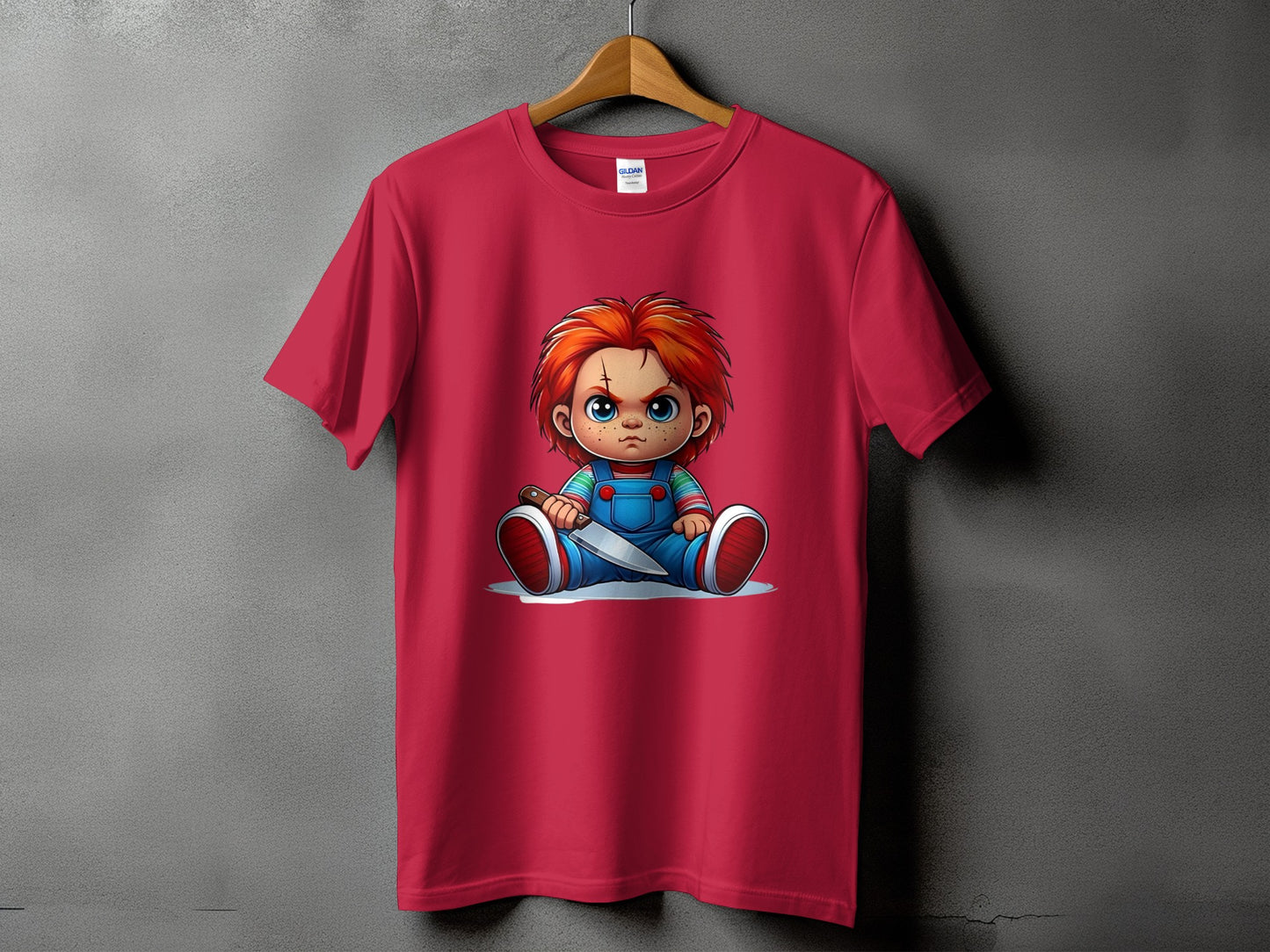 Red t-shirt with Chucky doll graphic holding a knife, sitting down.