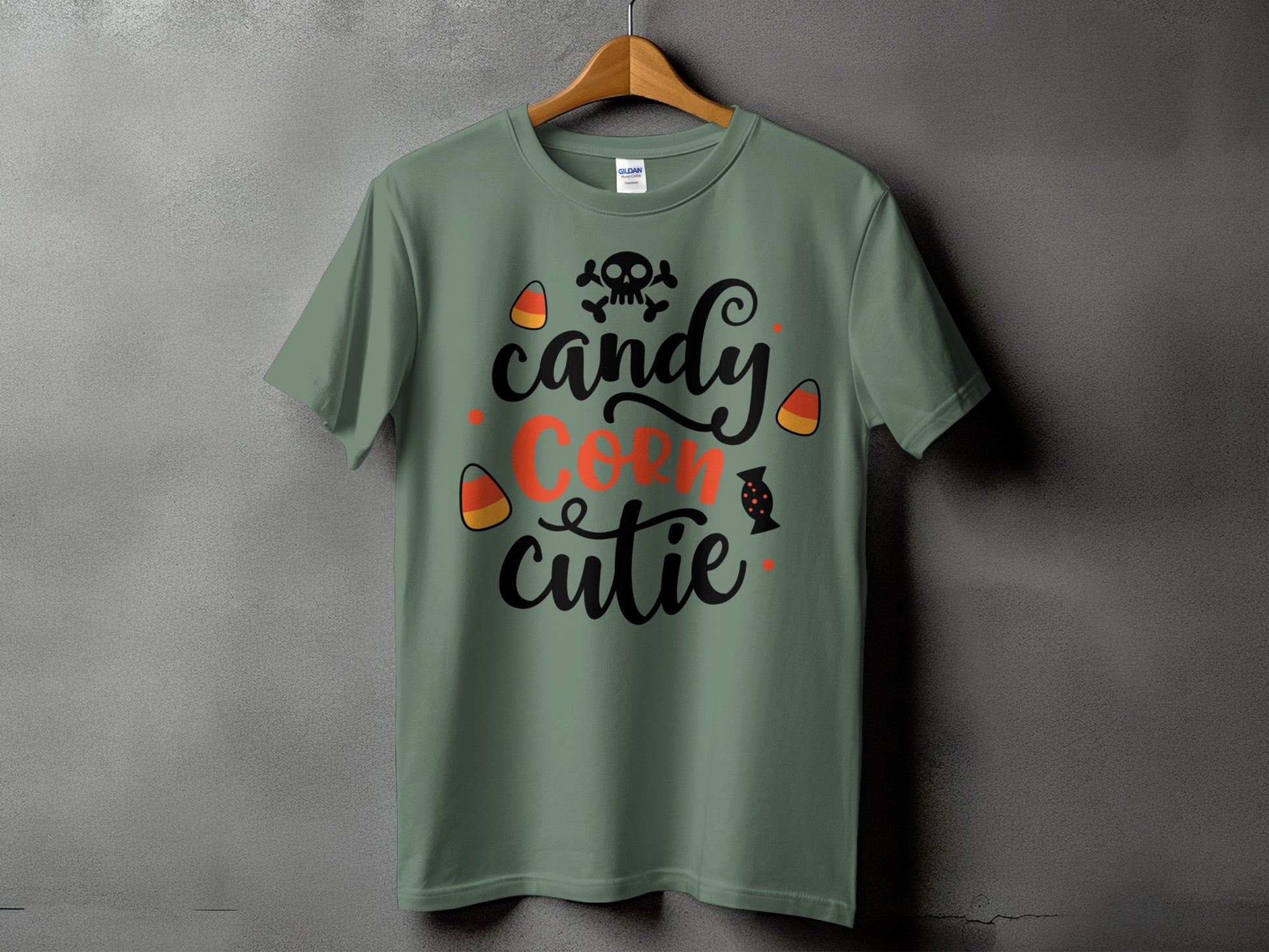 Green t-shirt with "candy corn cutie" text and Halloween icons.