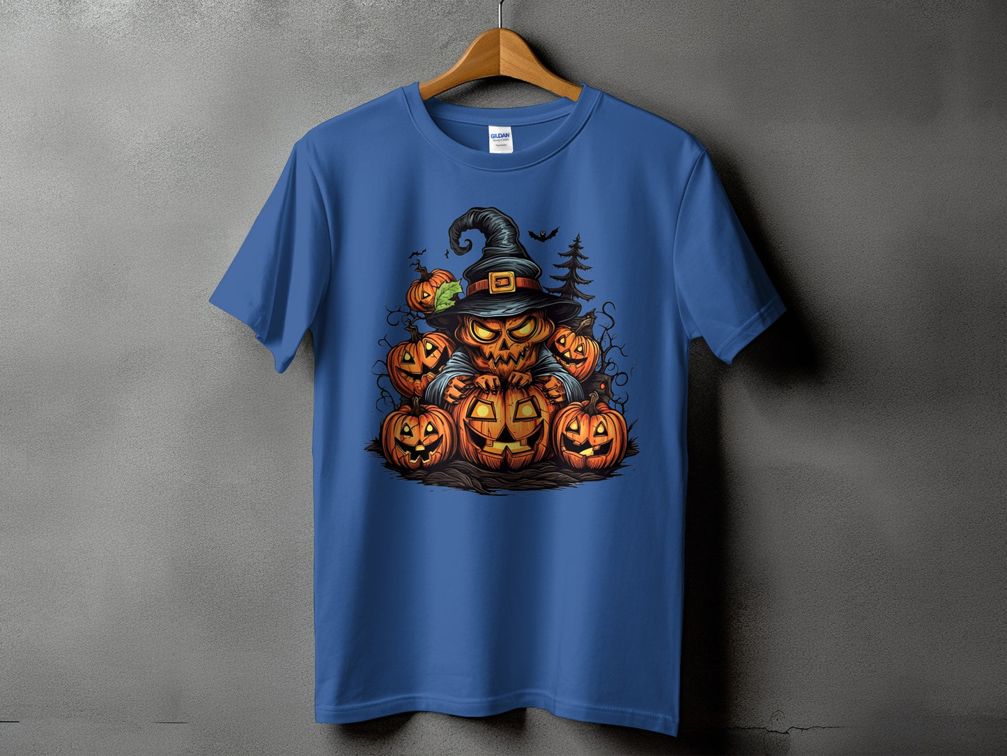 Blue t-shirt with a Halloween graphic of a pumpkin character with a hat surrounded by other pumpkins.