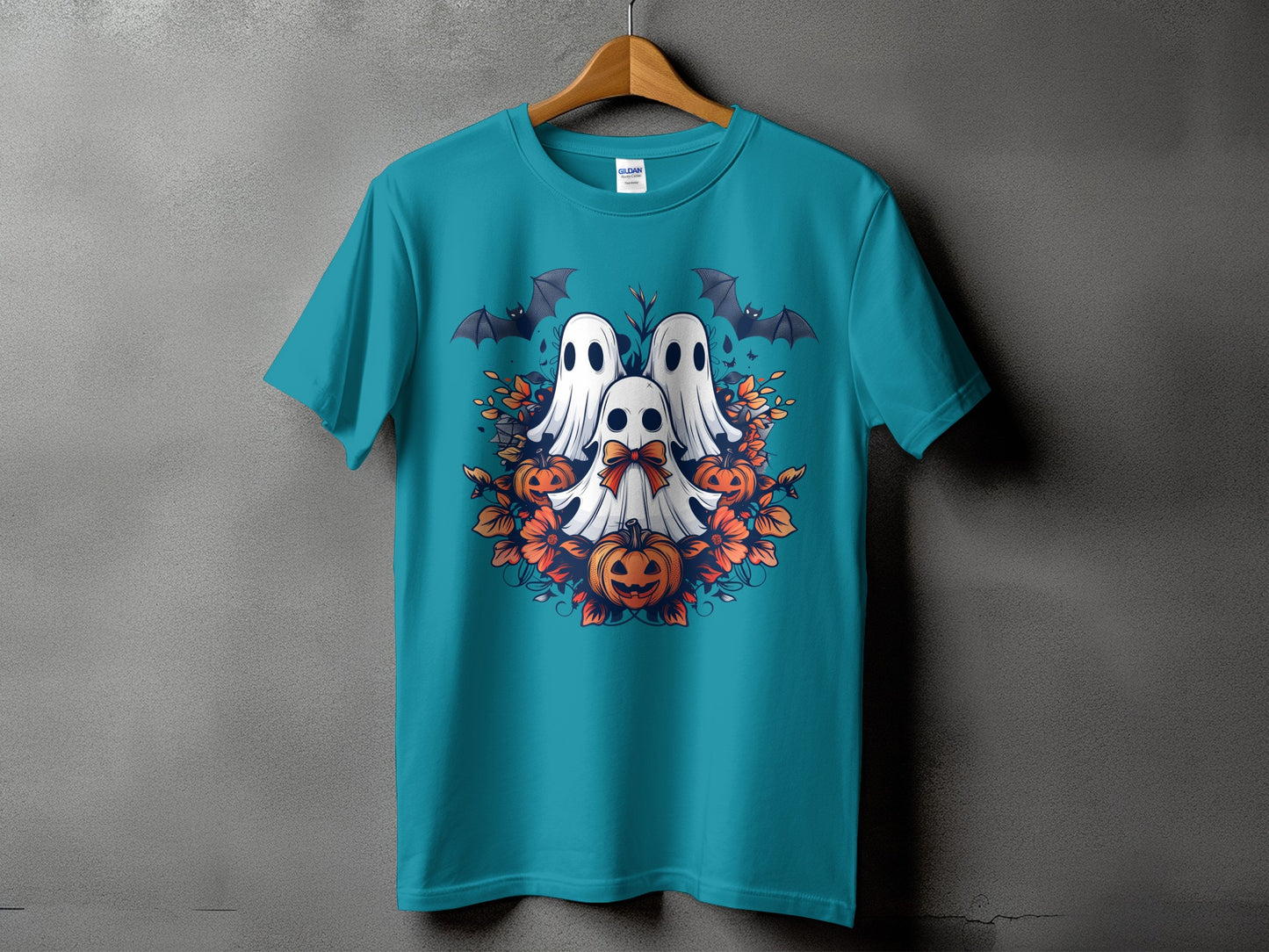 Teal t-shirt with Halloween ghosts, pumpkins, bats, and flowers graphic.