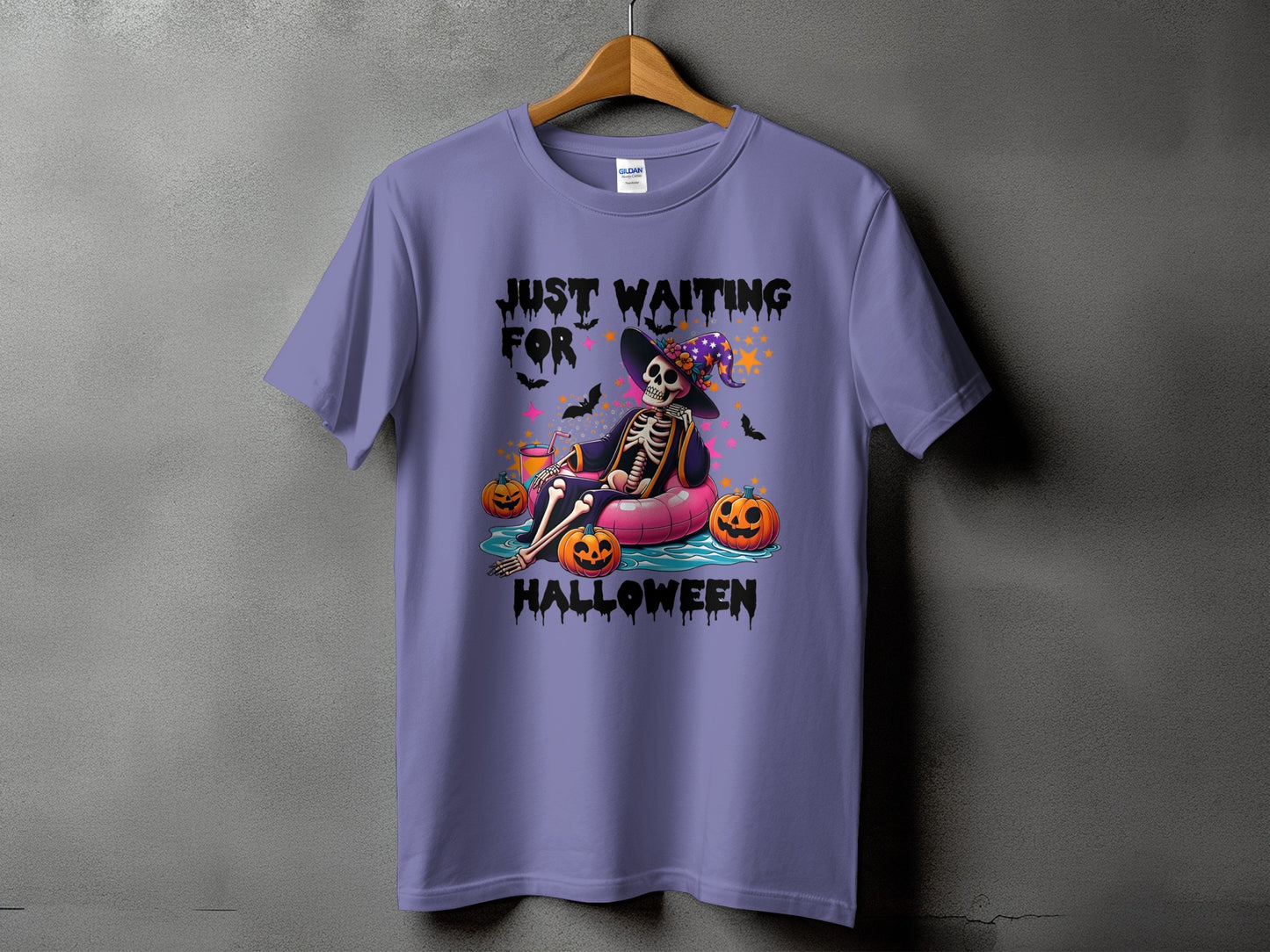 Purple t-shirt with skeleton in inner tube saying "Just Waiting For Halloween"