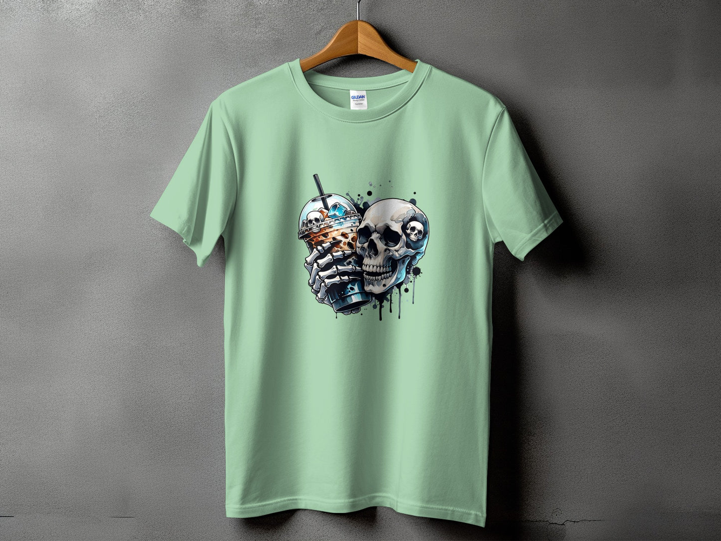 Mint green t-shirt with a graphic of a skull holding a bubble tea and another skull.