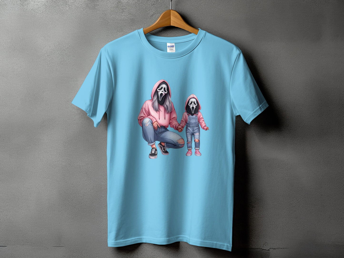 Light blue t-shirt with graphic of two people in ghost masks.