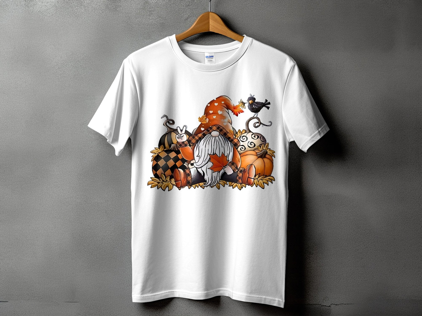 White t-shirt with a Fall gnome and pumpkins graphic design.