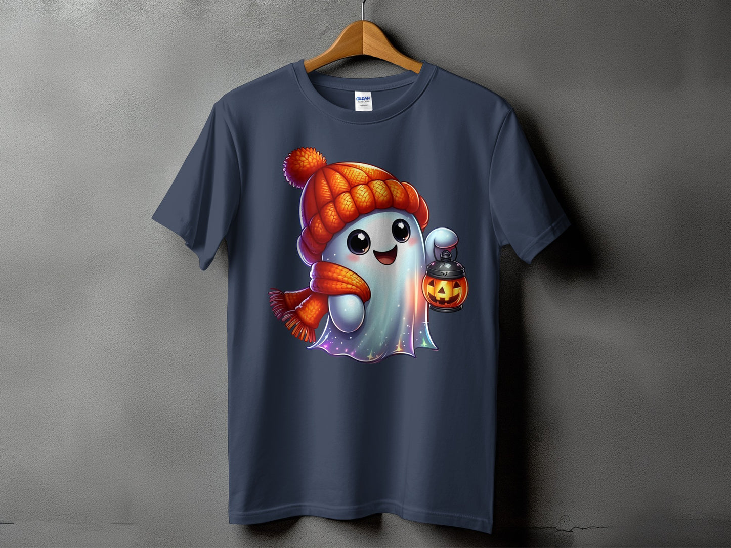 T-shirt with a cute ghost wearing a hat and scarf, holding a jack-o'-lantern.