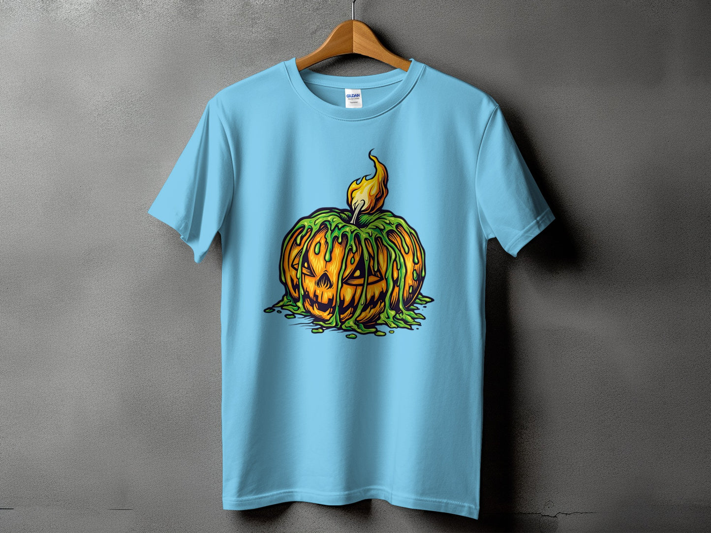 Light blue t-shirt with a cartoon jack-o'-lantern graphic covered in green slime.