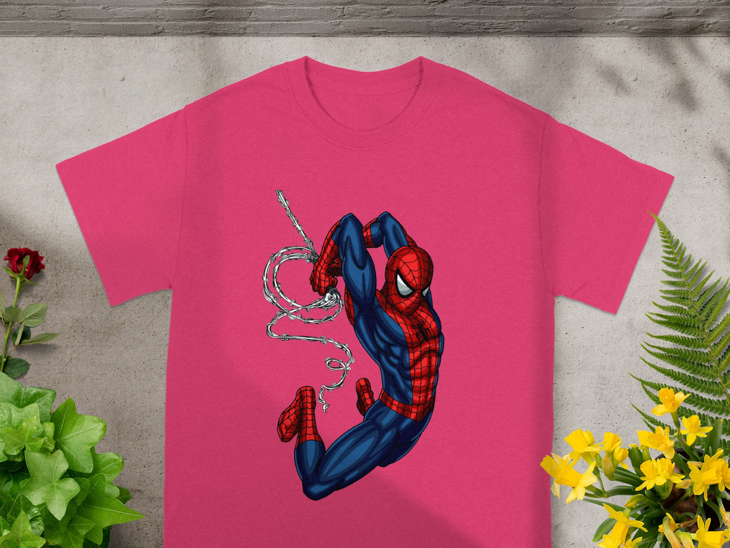 Pink t-shirt featuring Spider-Man swinging on a web.