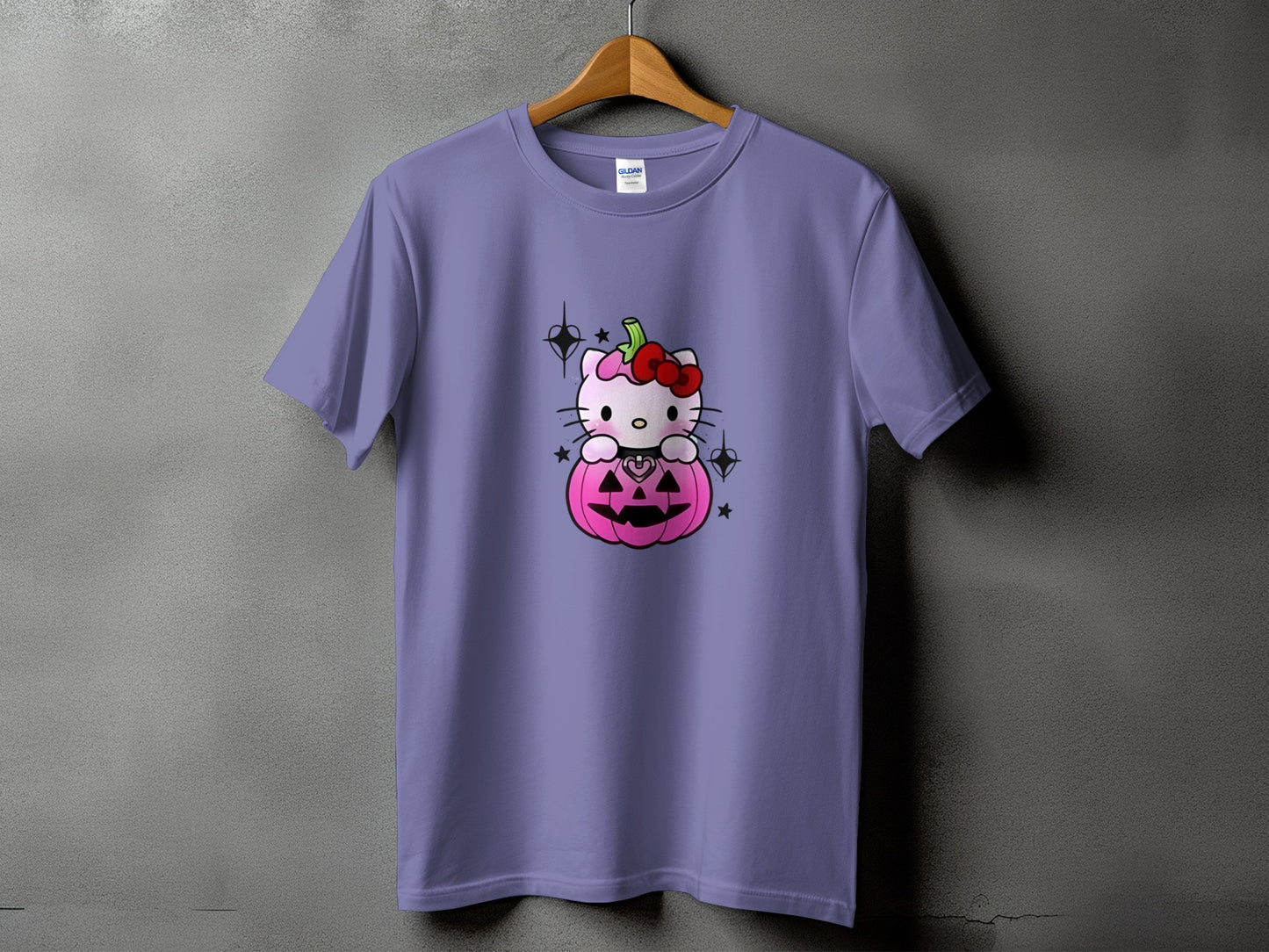 Purple t-shirt with Hello Kitty sitting in a pink jack-o'-lantern.