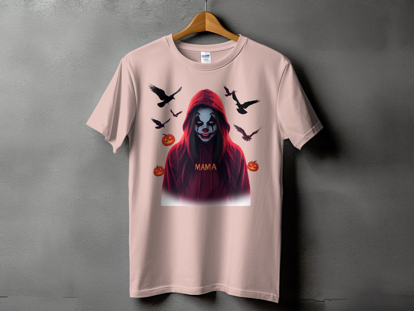 Pink t-shirt with a spooky clown graphic, pumpkins, and crows, "Mama" text.