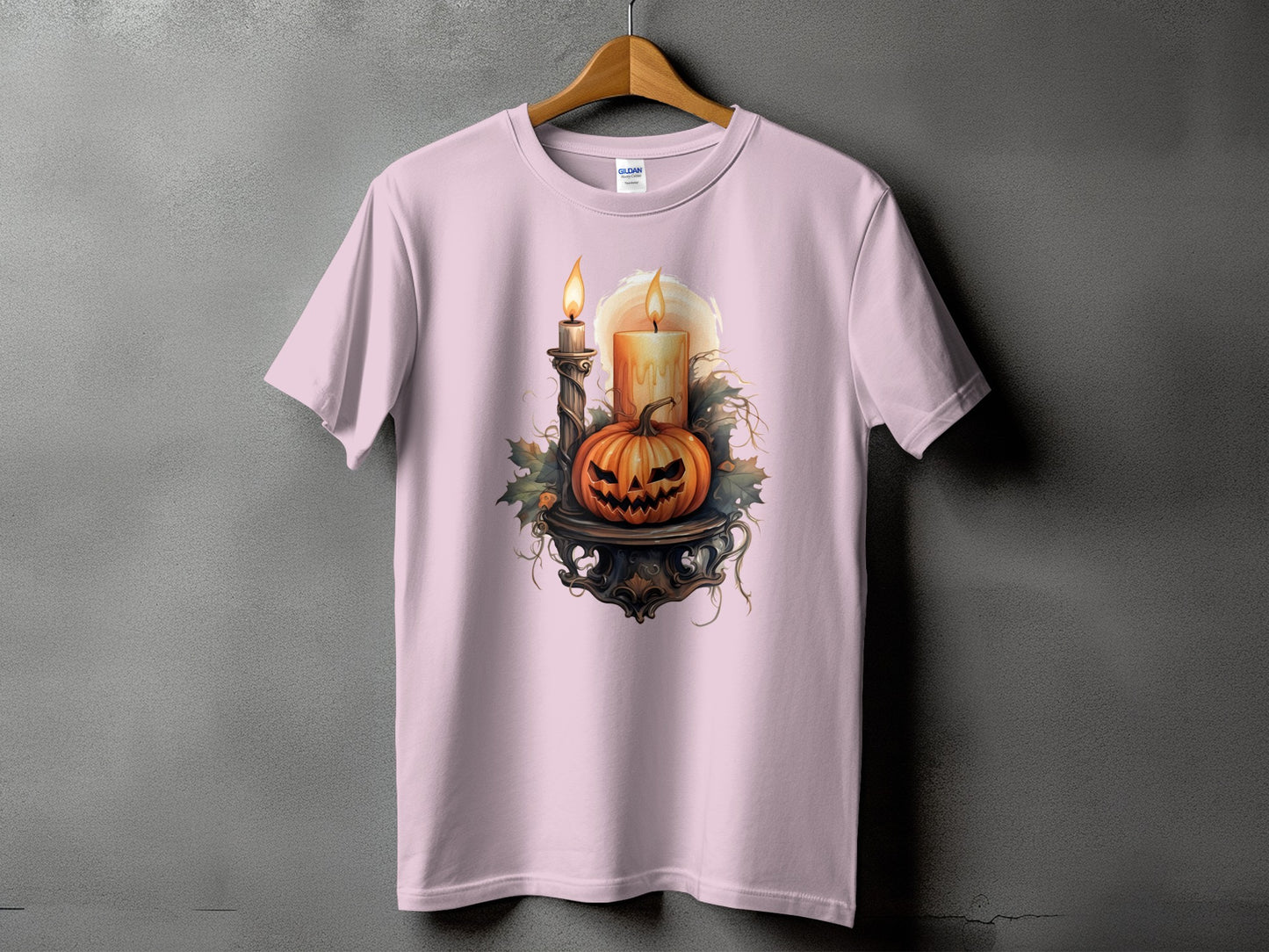 Pink t-shirt with a Halloween graphic of a carved pumpkin and candles.