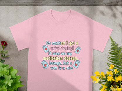 Pink t-shirt with "So excited I got a raise today!" text and medication icons.