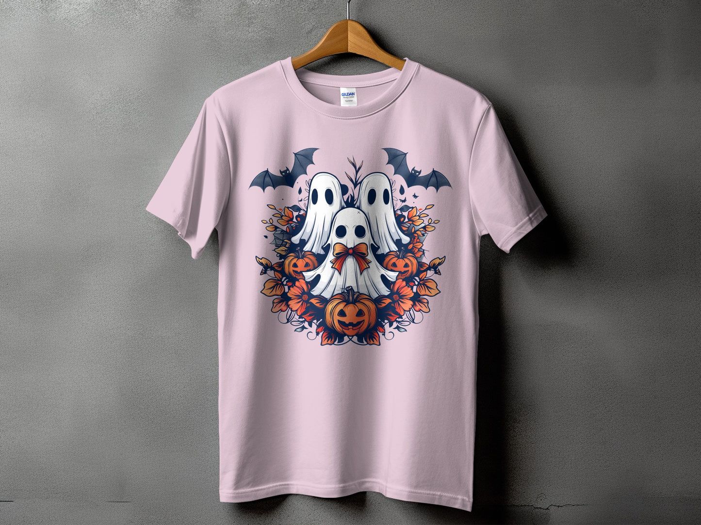 Pink t-shirt with three ghosts, pumpkins, bats, and floral Halloween design.