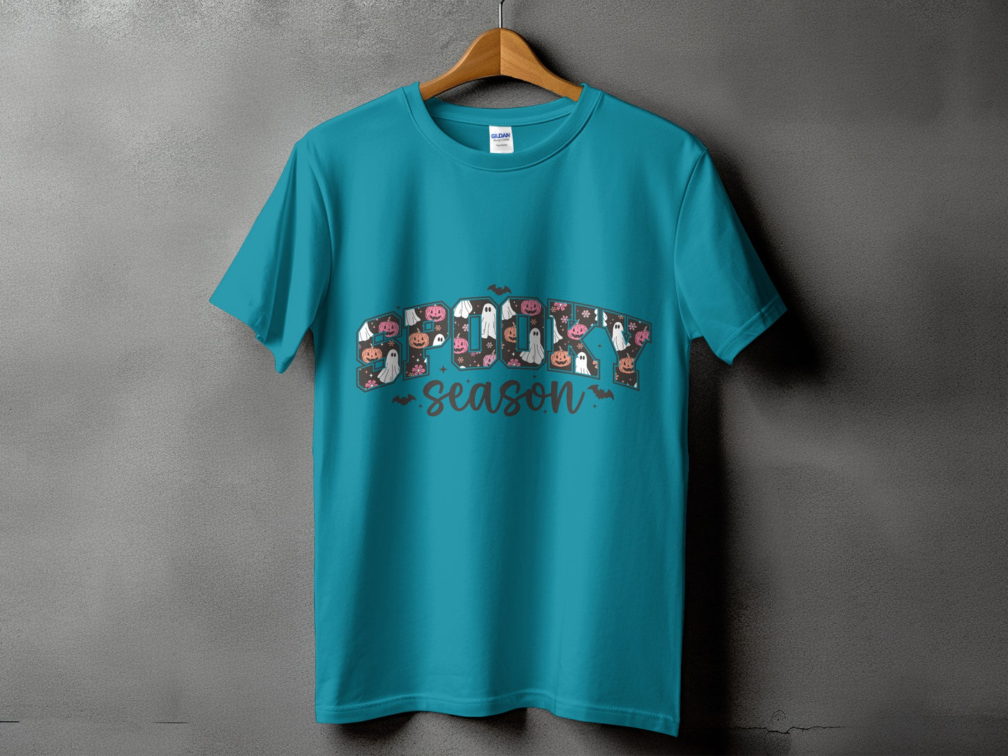 Teal t-shirt with "Spooky Season" text and Halloween illustrations.