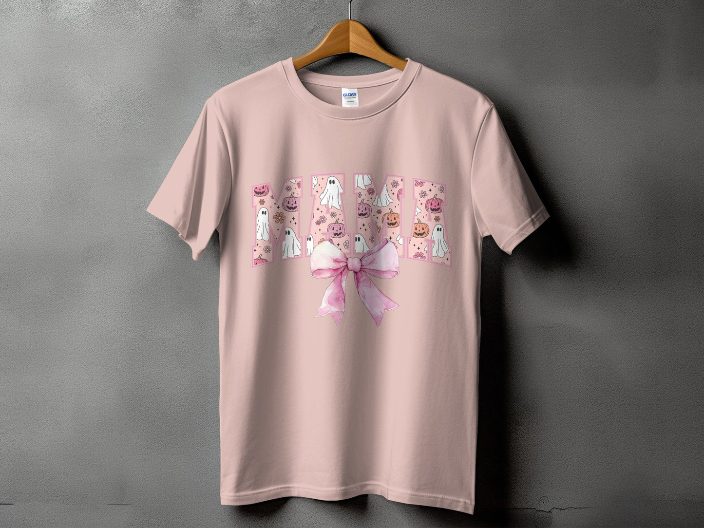 Pink t-shirt with "Mama" in letters filled with ghosts, pumpkins, and flowers.