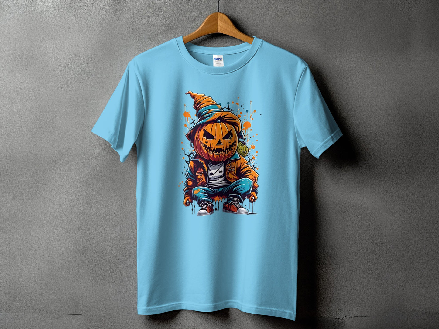 Light blue t-shirt with a cartoon pumpkin character in a hat and jacket graphic.