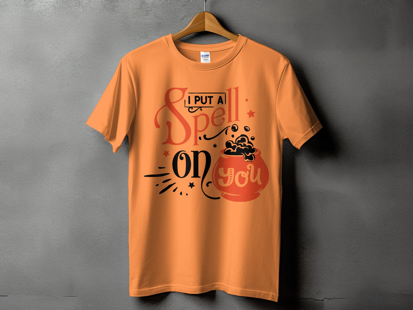 Orange t-shirt with "I Put A Spell On You" text and cauldron graphic.