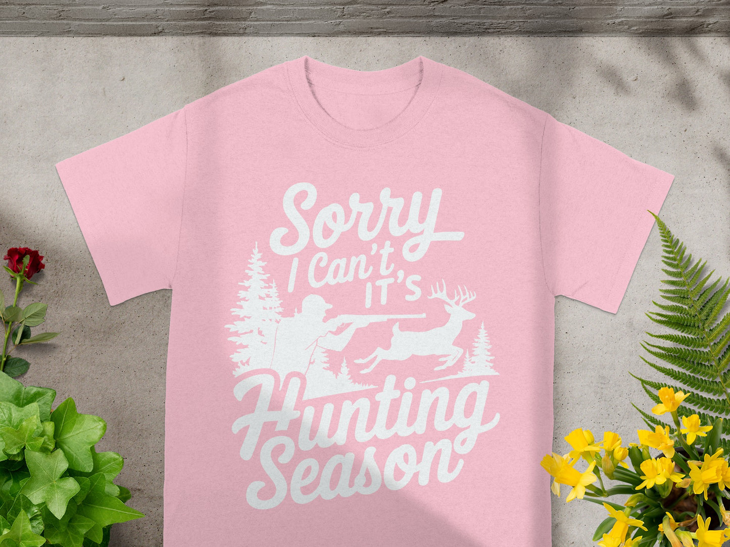 Pink t-shirt with "Sorry I Can't It's Hunting Season" text and hunting graphic.