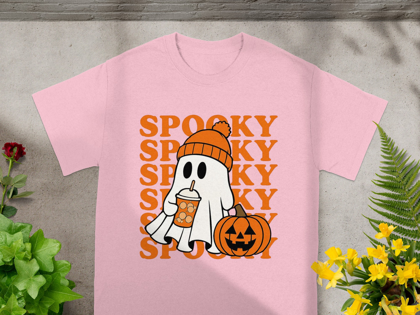 Pink t-shirt with a cartoon ghost, pumpkin, and text "SPOOKY".