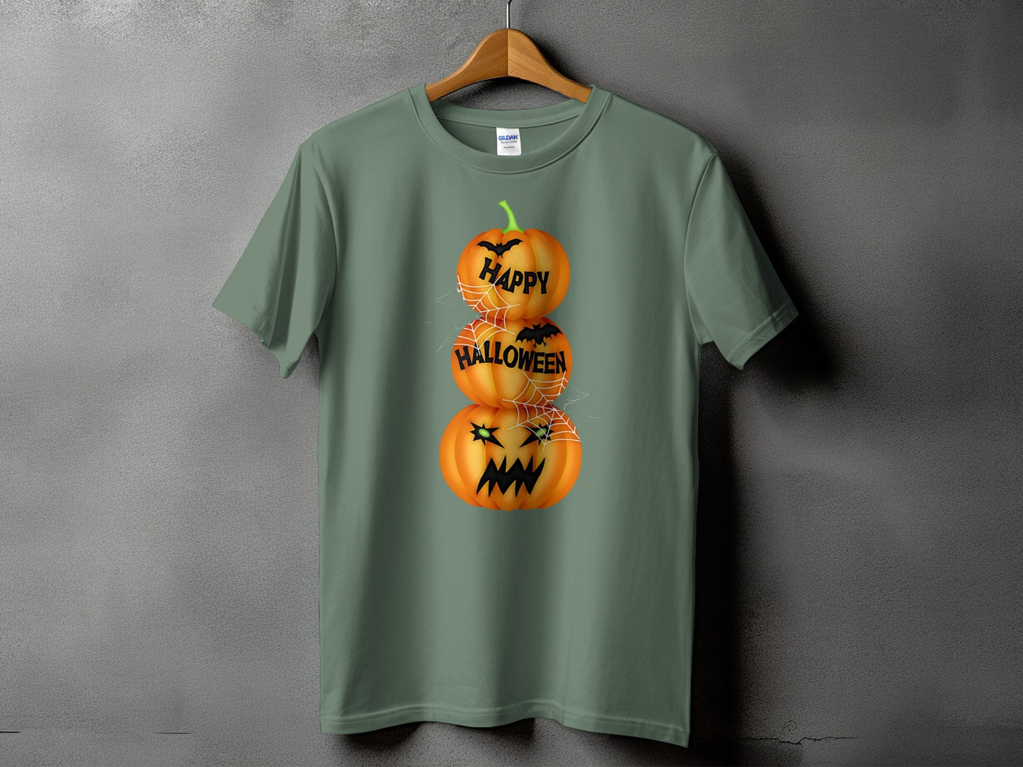 Green t-shirt with stacked pumpkins saying "Happy Halloween" and spiderwebs.