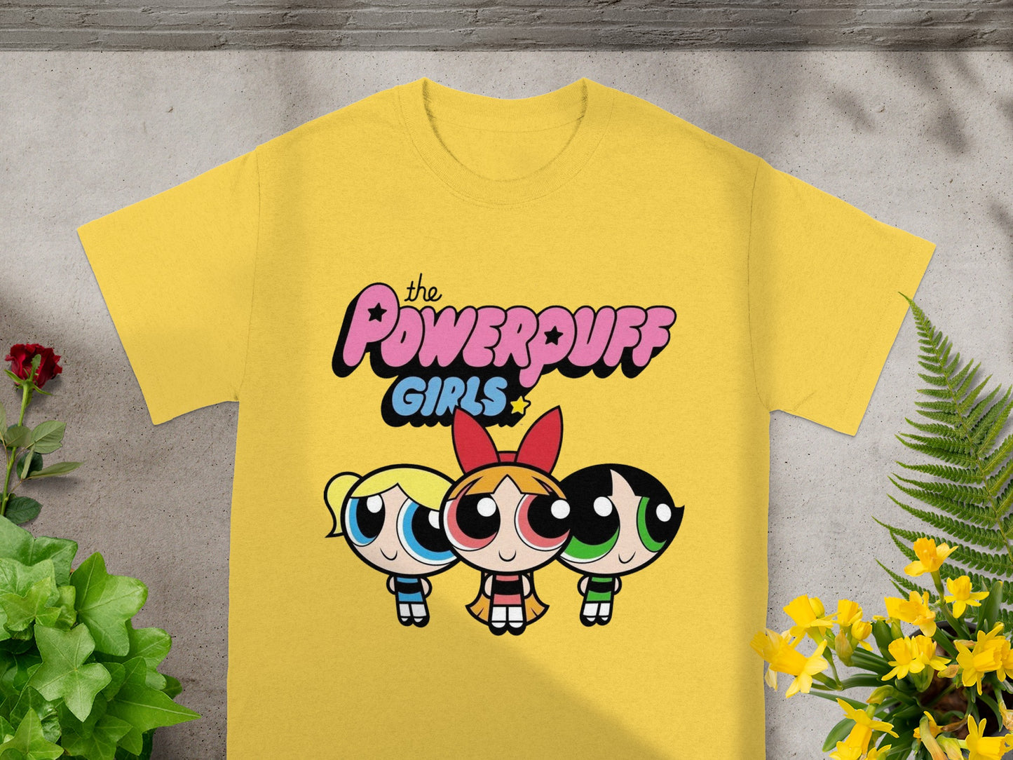 Yellow t-shirt with The Powerpuff Girls graphic featuring Blossom, Bubbles, and Buttercup.
