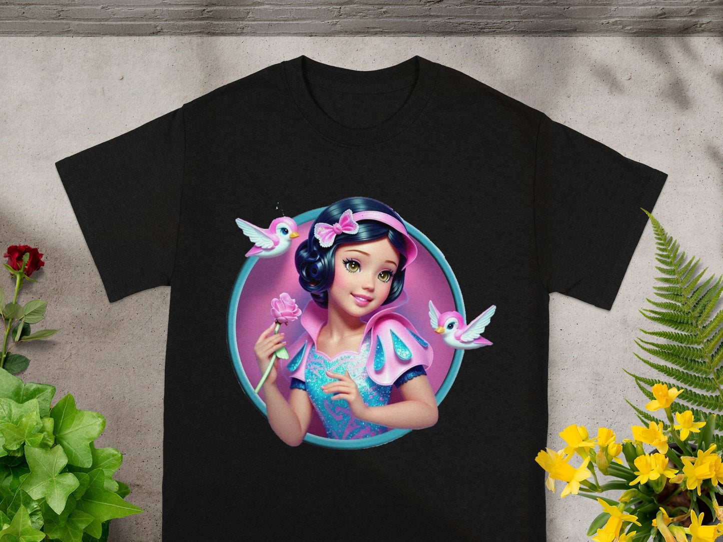 Black t-shirt featuring a circular graphic of Snow White holding a rose, with two pink birds.