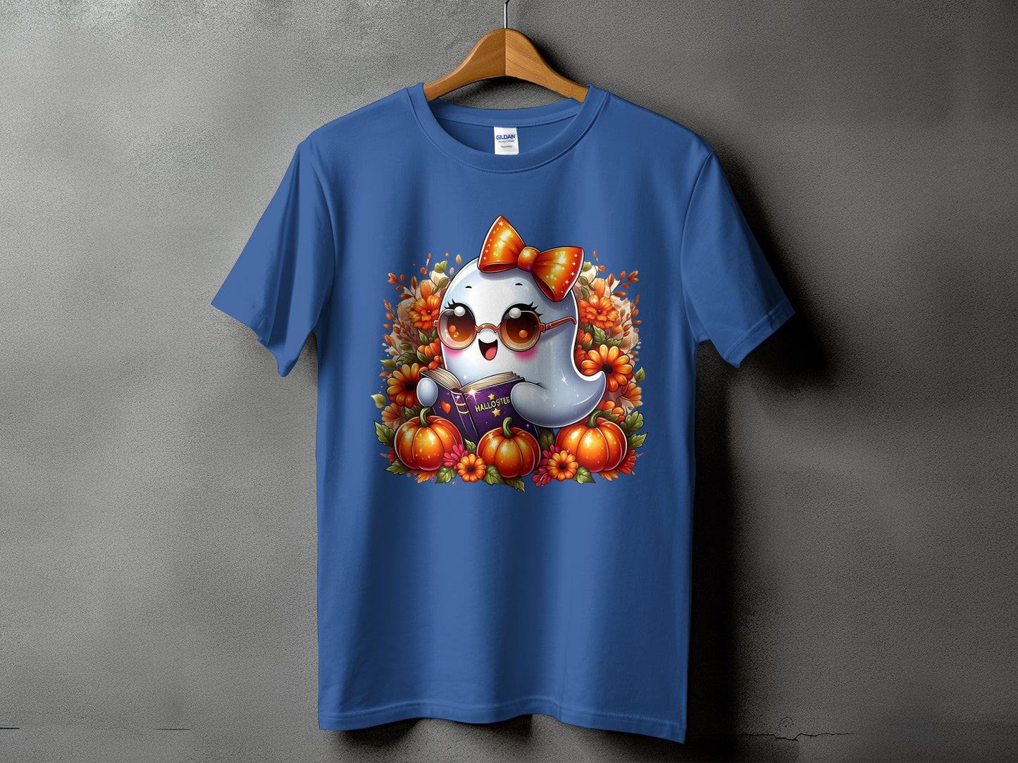 Blue t-shirt featuring a cute ghost wearing a bow and sunglasses, reading a book.