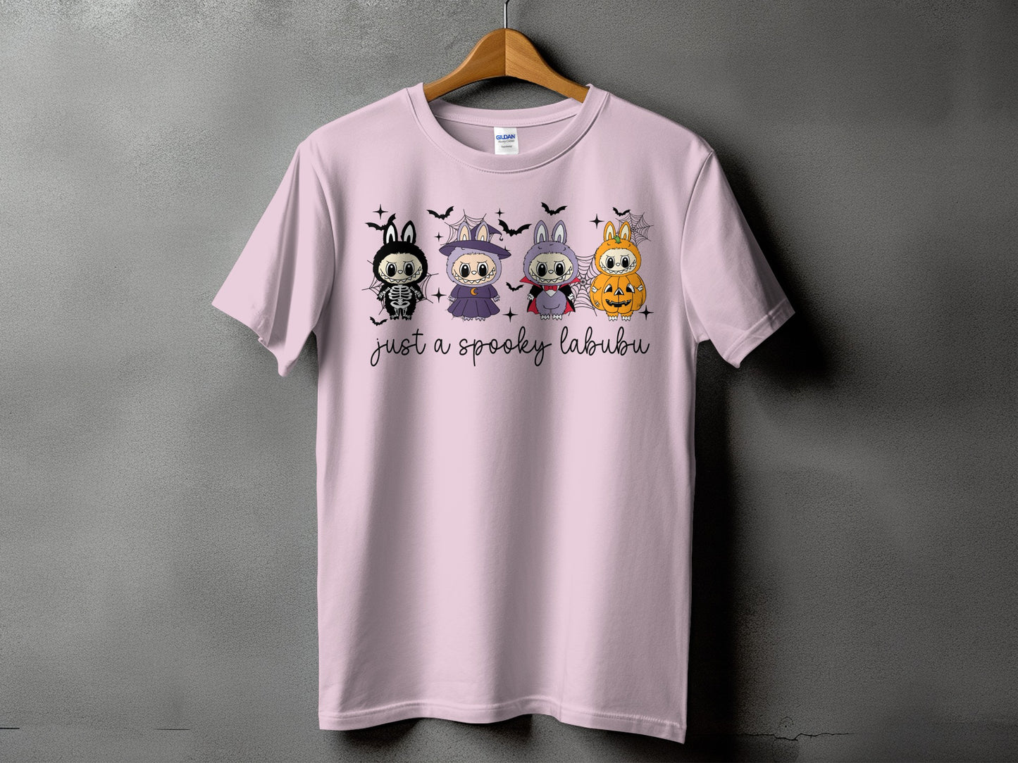 Pink t-shirt with "just a spooky labubu" text and four Halloween-themed characters.