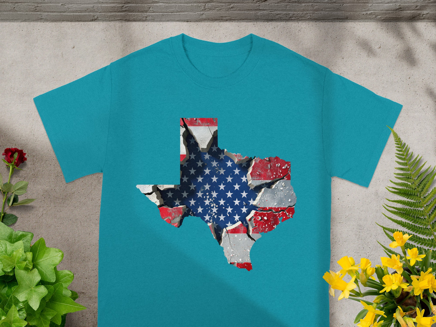 Teal t-shirt with Texas silhouette featuring cracked American flag design.