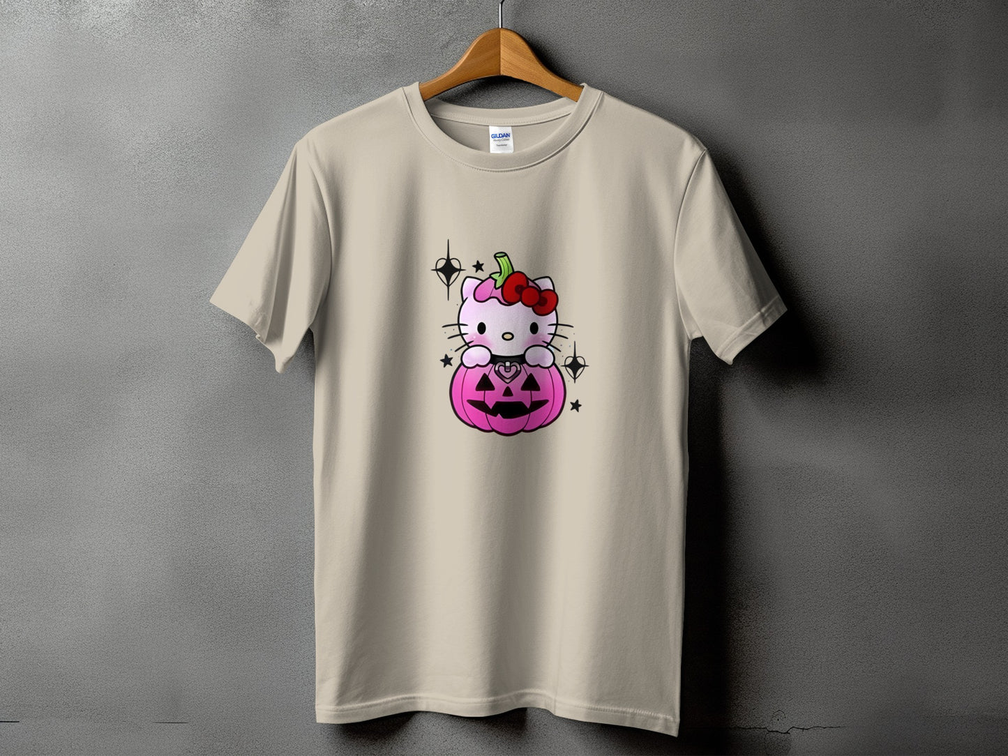Hello Kitty sits in a pink jack-o'-lantern with a red bow and black stars.