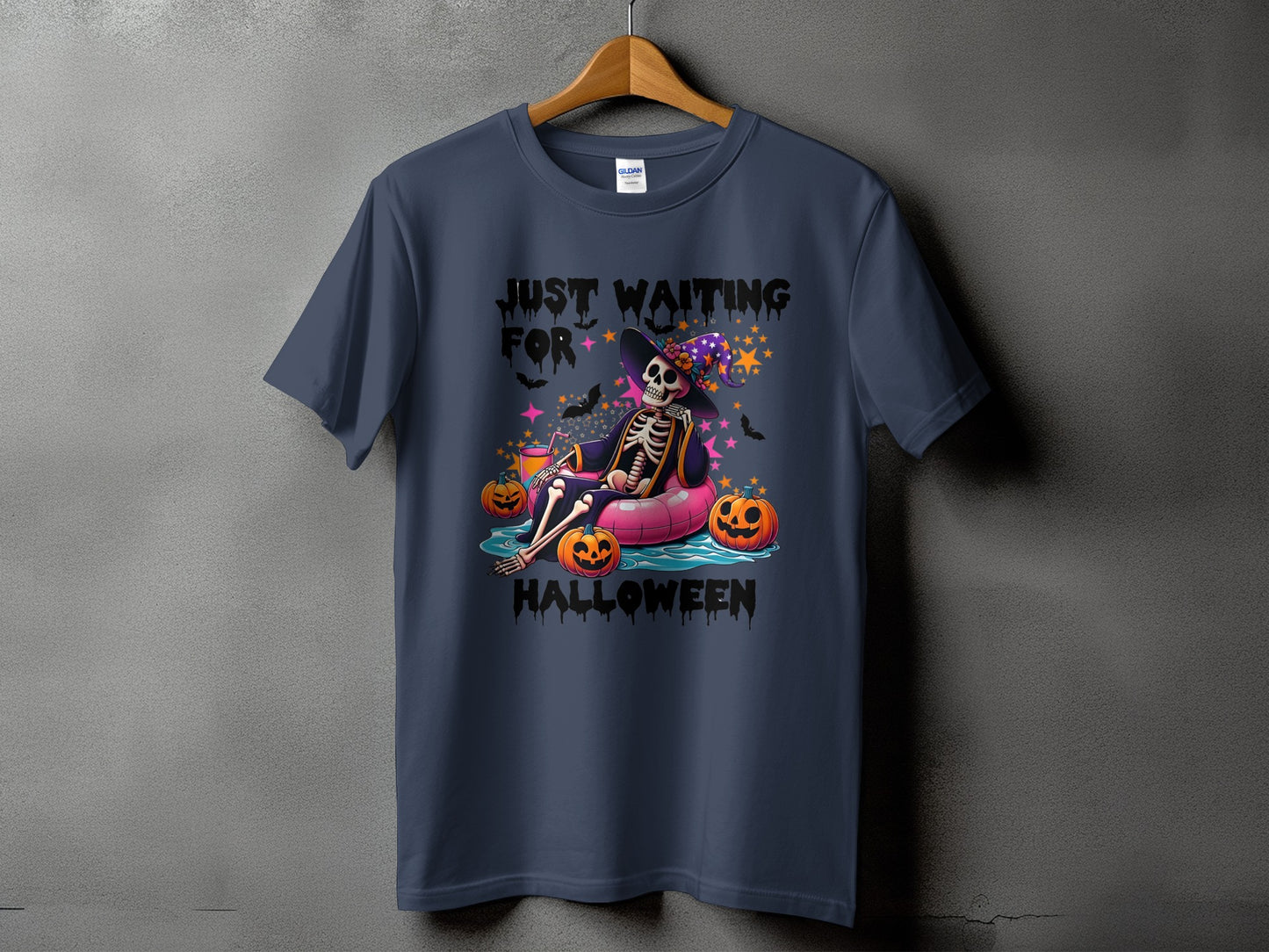 Skeleton in a witch hat on a pink float with pumpkins and text "JUST WAITING FOR HALLOWEEN".