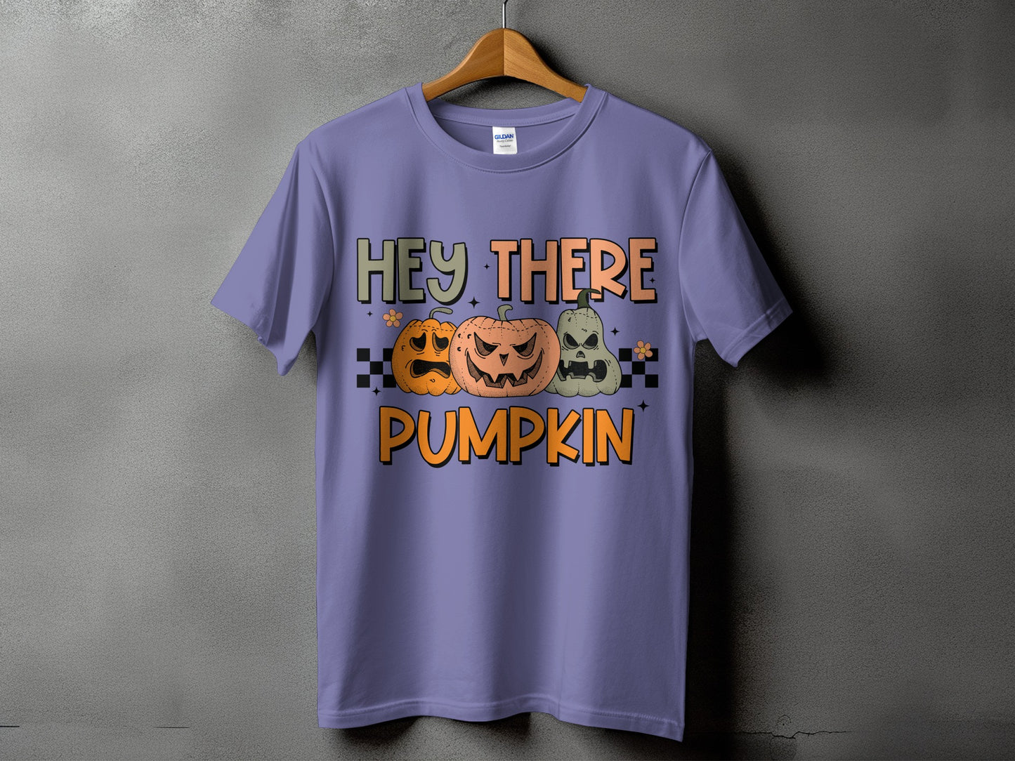 Purple t-shirt with "Hey There Pumpkin" text and three carved pumpkins.