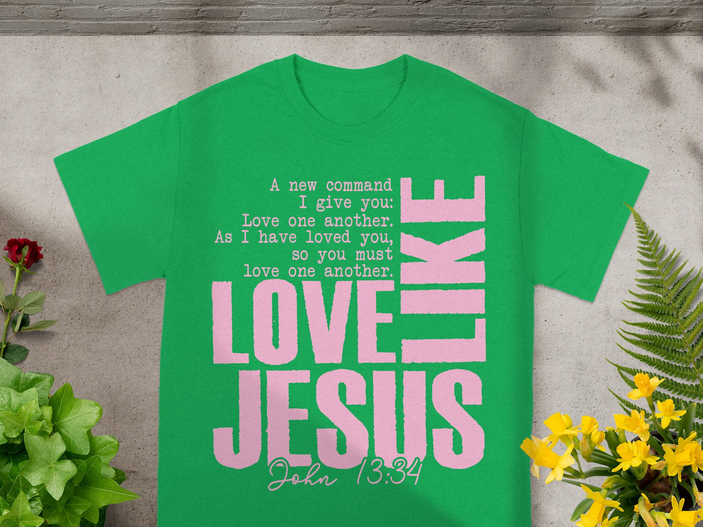 Green t-shirt with pink text "Love Jesus" and "John 13:34" scripture.