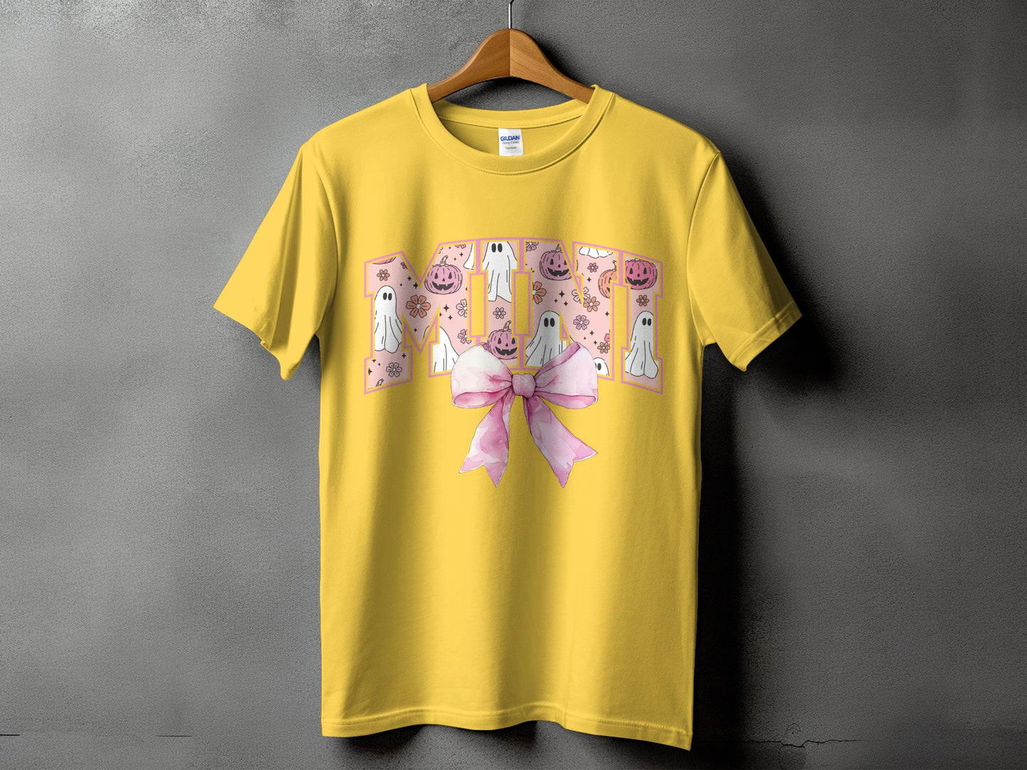 Yellow t-shirt with "MOM" text featuring ghosts, pumpkins, and flowers