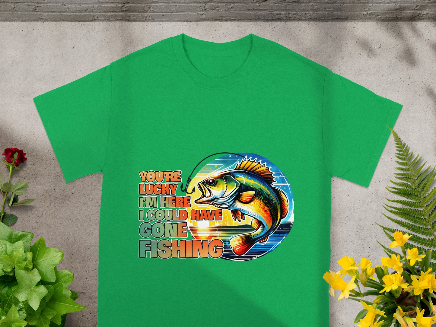 Green t-shirt with colorful fish and text: "You're lucky I'm here I could have gone fishing."