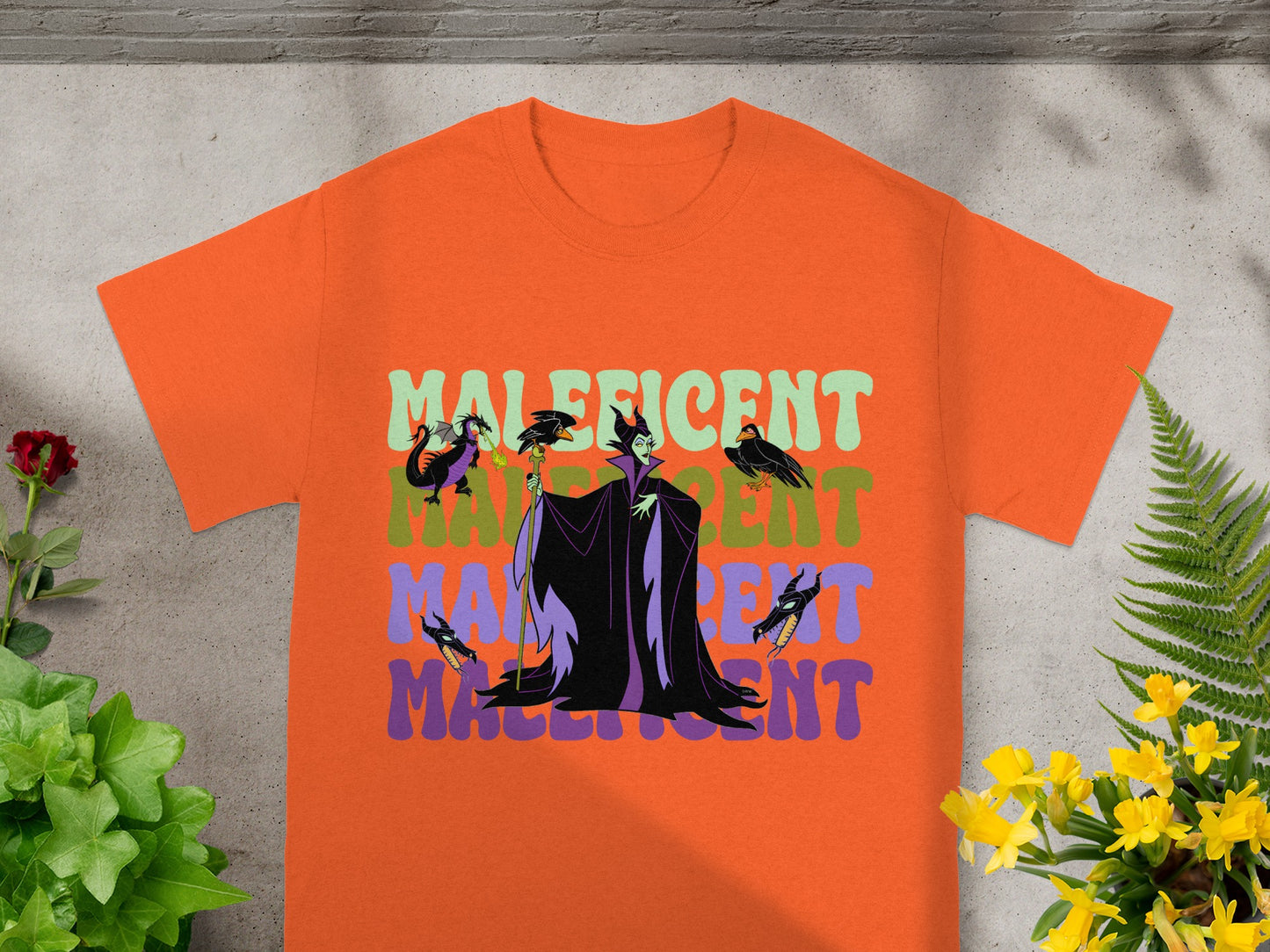 Orange t-shirt with Maleficent graphic and text.