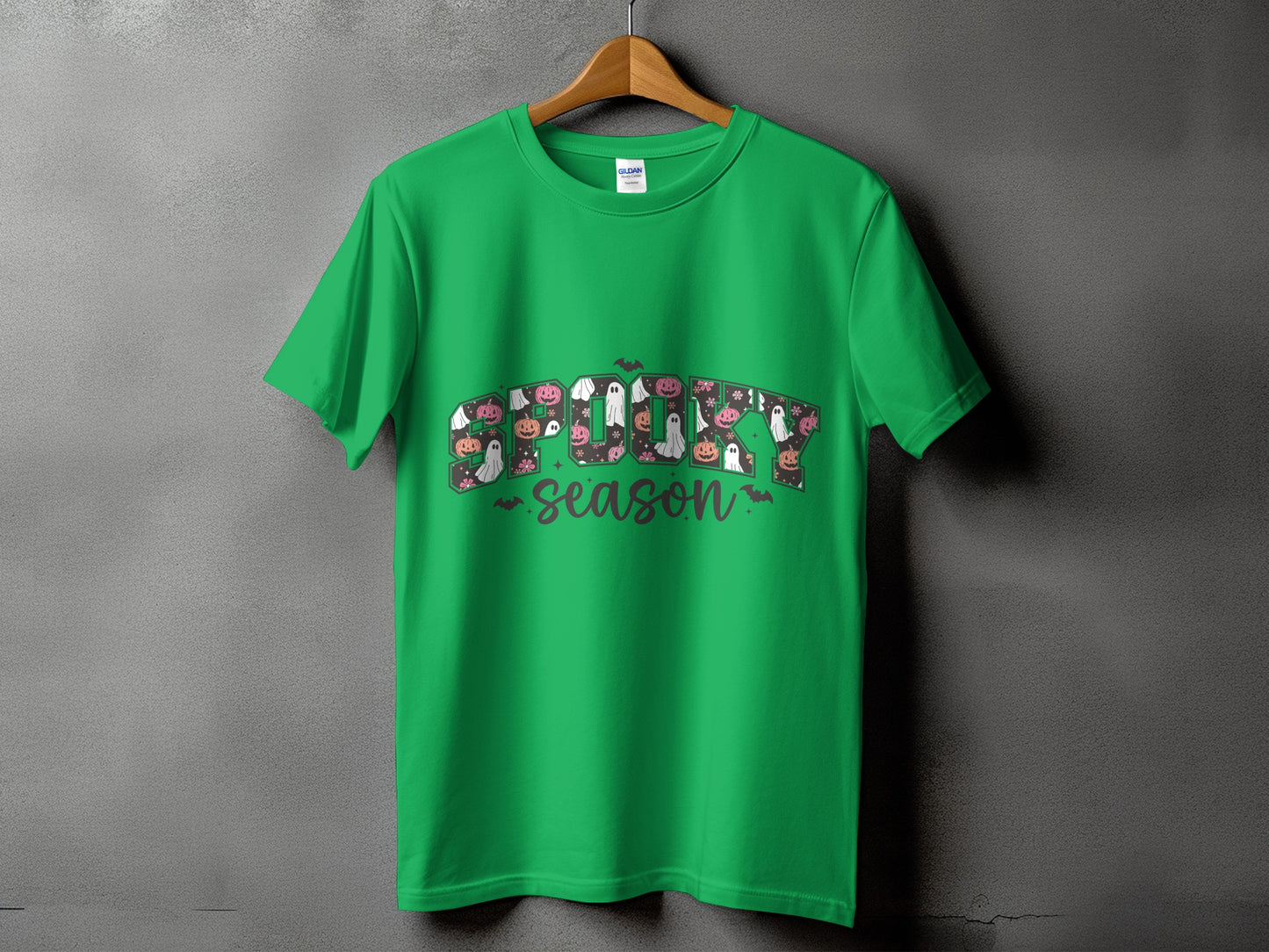 Green t-shirt with "Spooky Season" text featuring Halloween icons.