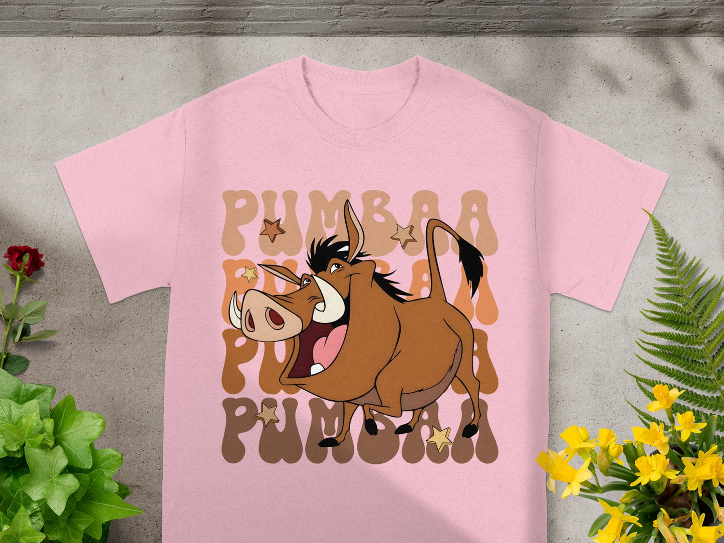 Pink t-shirt with cartoon Pumbaa from The Lion King graphic.