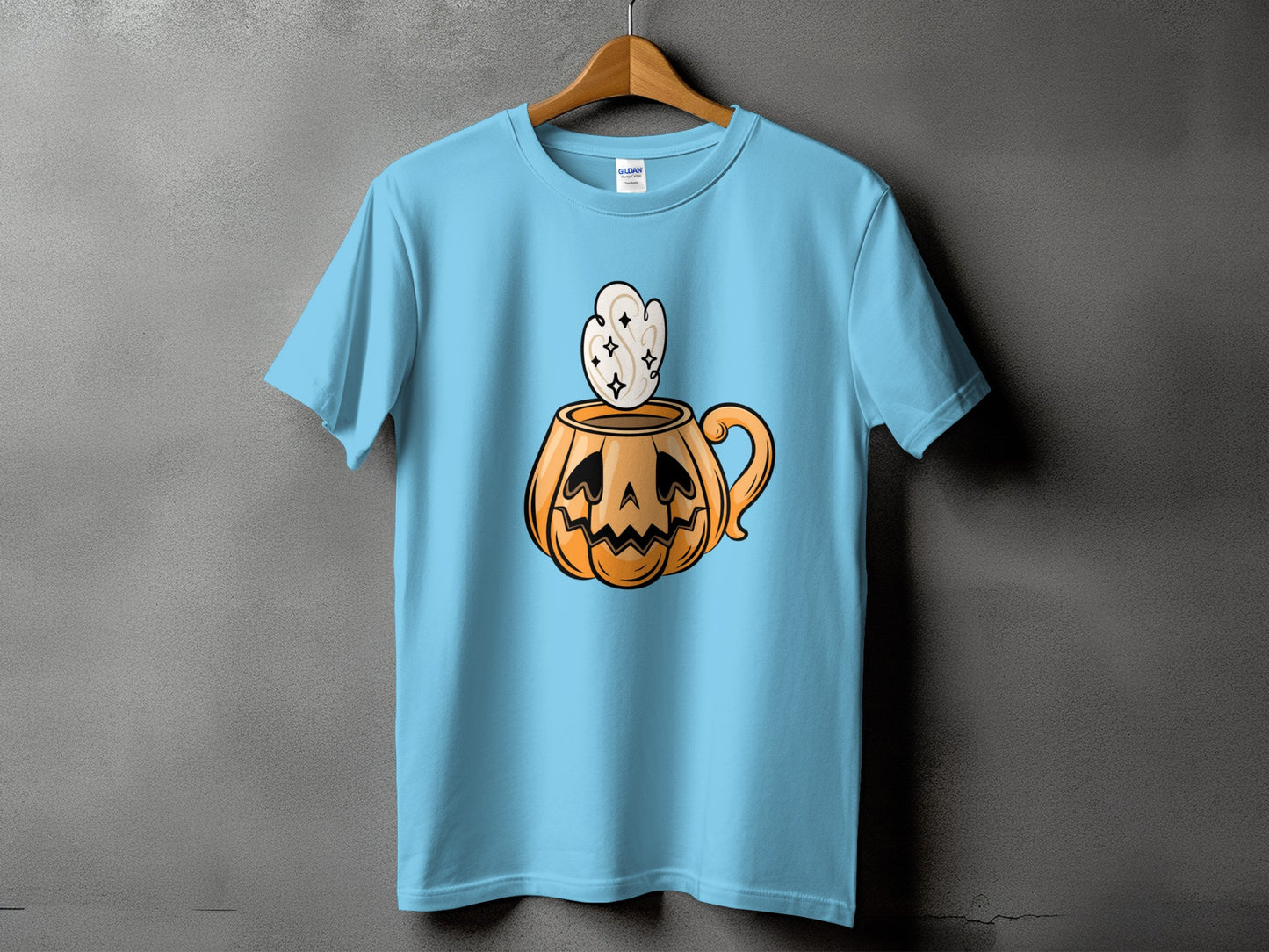 Light blue t-shirt featuring a jack-o'-lantern mug with swirling steam.